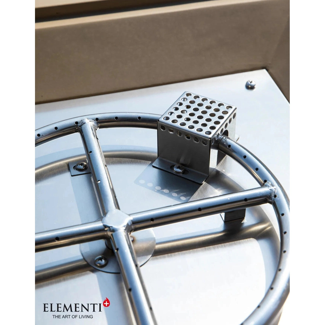 Silver metallic burner assembly with perforated square component mounted on circular stainless steel frame for elementi plus uluru fire table 16 kw