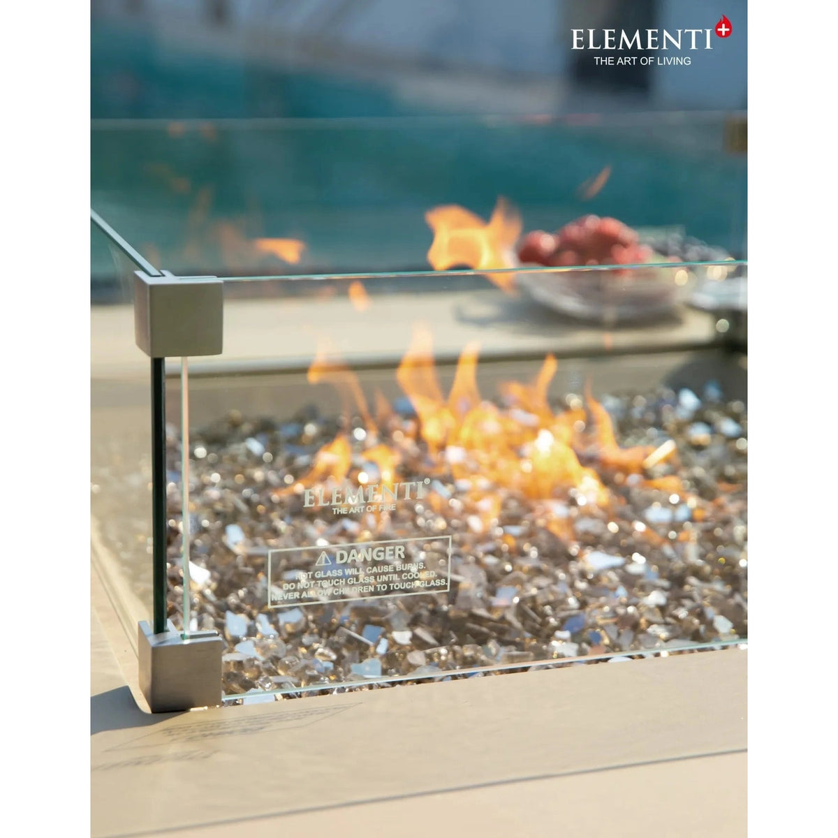 Elementi Plus Uluru Fire Table glass fire pit with modern transparent panels and metallic silver corner brackets