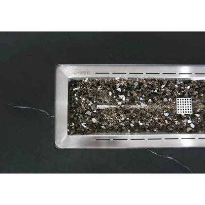 Rectangular stainless steel fire pit insert filled with reflective metallic glass shards in elementi plus varna fire table