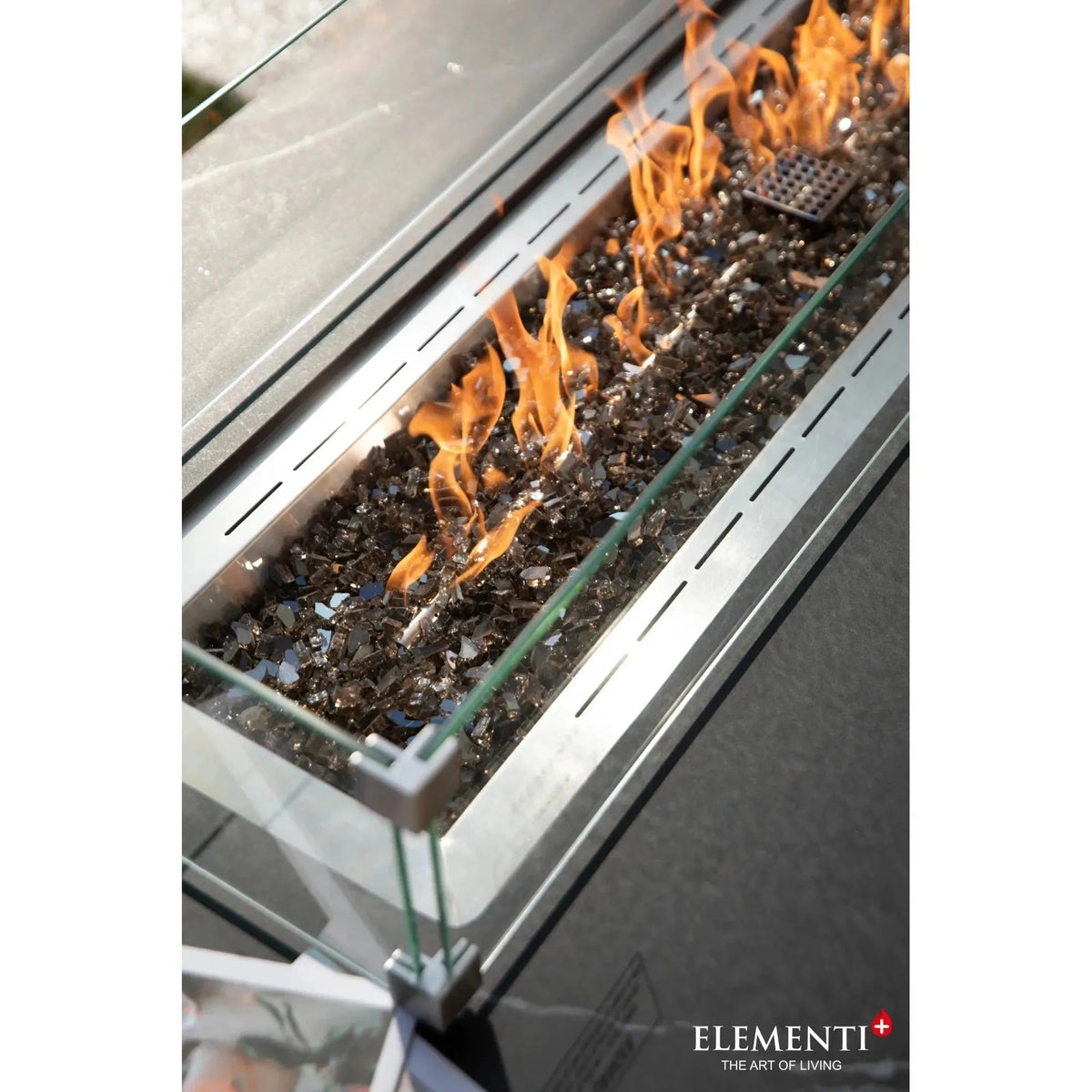 Modern stainless steel Elementi Plus Varna fire table with glass enclosure and black flame-resistant glass beads