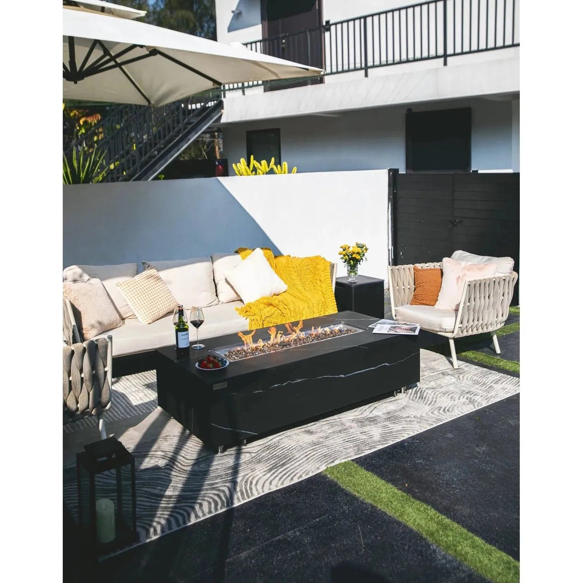 Black rectangular Elementi Plus Varna fire table with sleek modern design and visible flames 16 kW OFP121BB