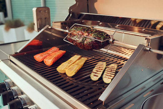 Grilled roast beef seasoned with herbs on stainless steel rotisserie spit in Enders Kansas Pro 3 rotisserie kit EN7901