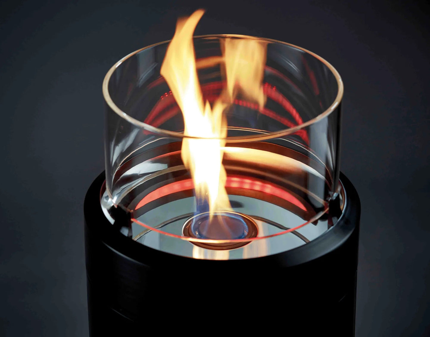 Modern black cylindrical ethanol fireplace with clear glass top and flickering flame enders large black nova led flame patio heater