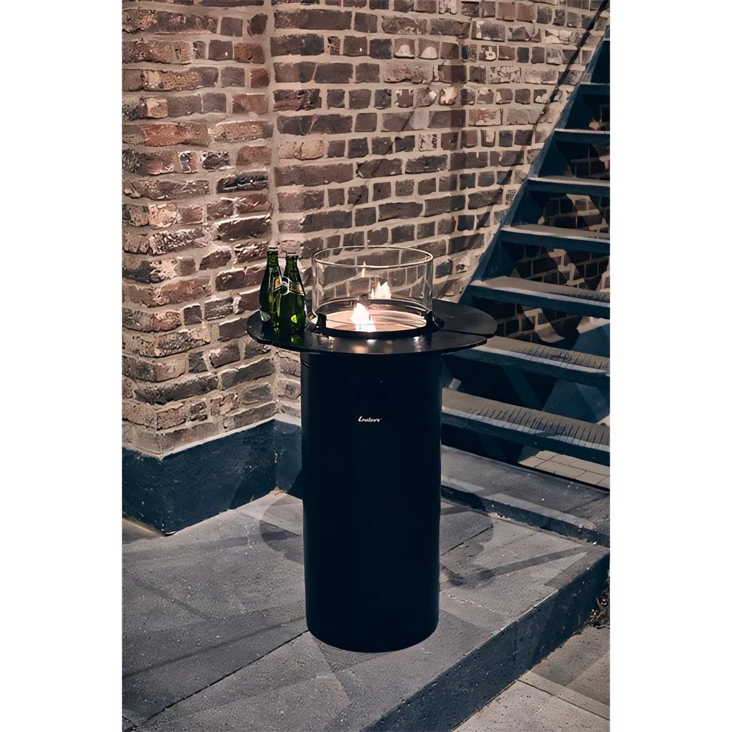Black cylindrical outdoor fire pit with glass top and lit flame minimalist design enders nova led flame patio heater shelf set