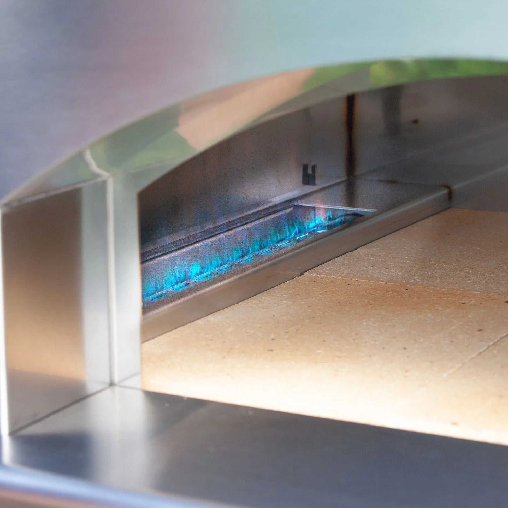 Stainless steel fontana margherita anthracite dual fuel pizza oven with blue flames and ceramic baking stone inside