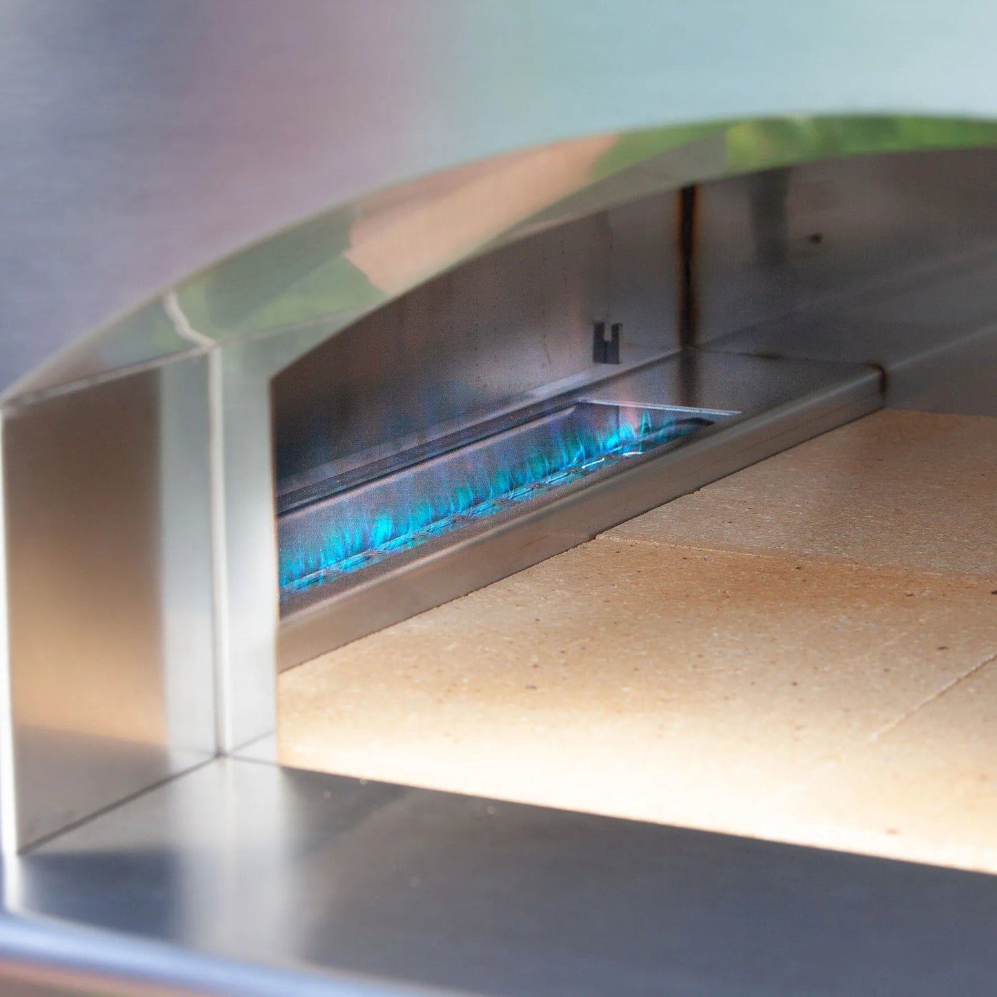 Fontana Margherita Rosso stainless steel gas-fired pizza oven with blue flames and ceramic baking stone inside