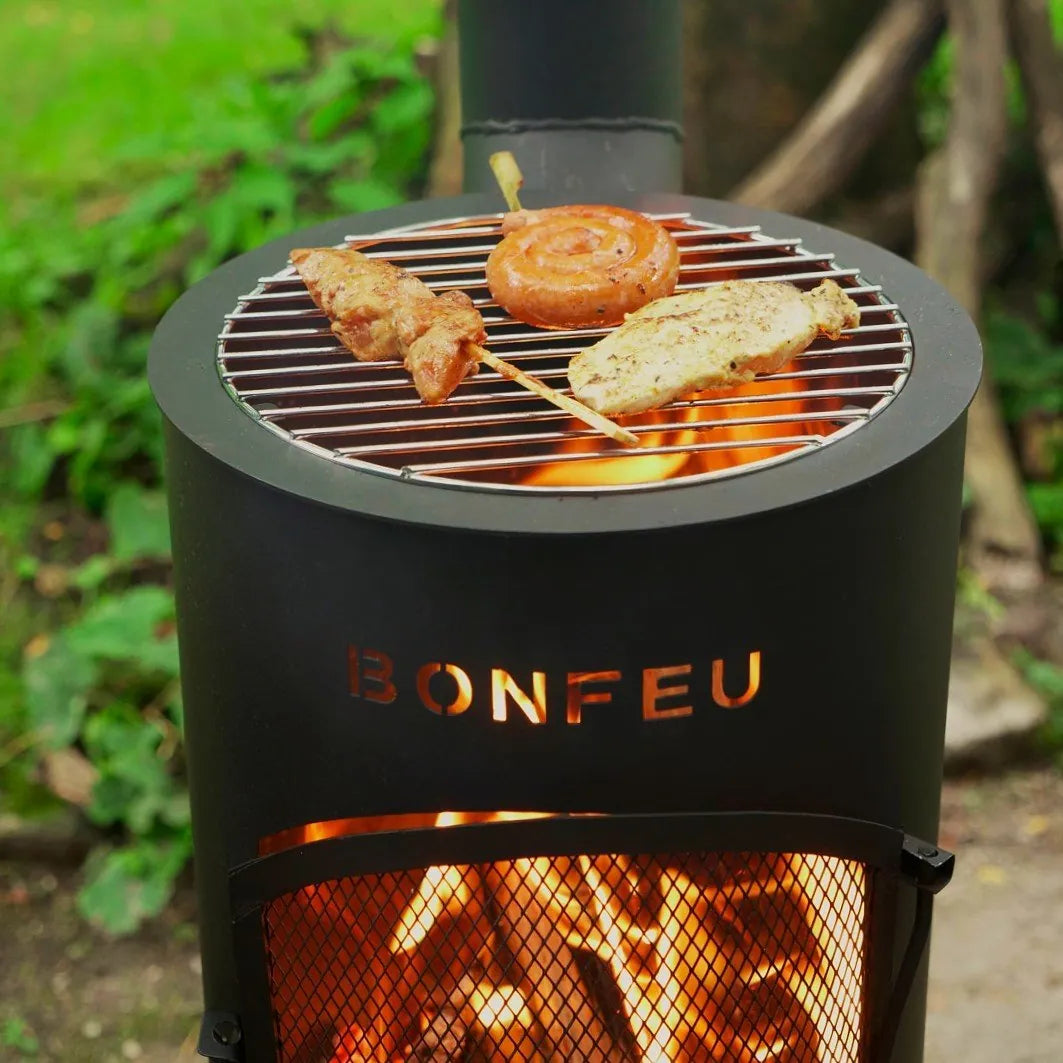 Black cylindrical bonfeu bongiano sp outdoor fireplace with metal grate in black and corten steel for outdoor use