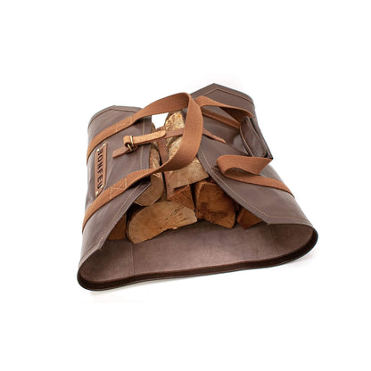 Brown leather bonfeu log bag with tan straps and ponte brand label designed for carrying firewood efficiently