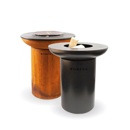 Two bonfeu bonbiza plancha grill fire pits in rusted copper and matte black with circular wood grates outdoors