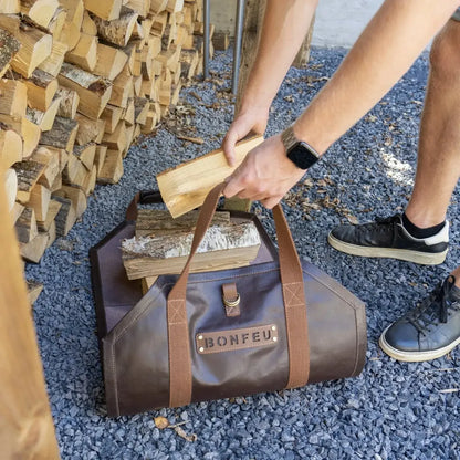Brown leather firewood carrier with tan straps and bonfeu branded patch for carrying logs easily