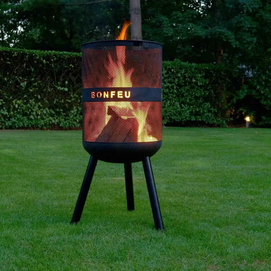 Black perforated metal bonfeu bonves 45 fire pit standing on three legs outdoors for outdoor use