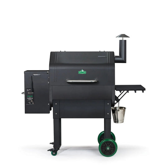 Black gmc pellet grill with green wheels and a stainless steel bucket side attachment for smoking and grilling