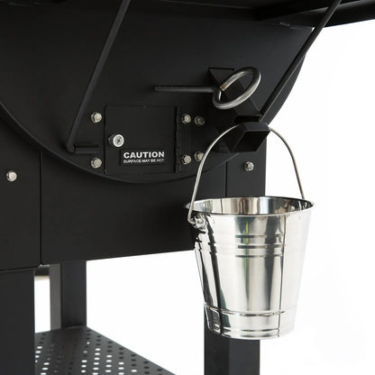 A shiny metallic silver bucket with handle hangs on the black GMG ledge prime plus wifi pellet grill smoker
