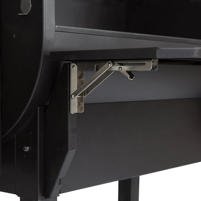 Stainless steel foldable shelf bracket attached to a black gmg peak prime plus wifi pellet grill smoker