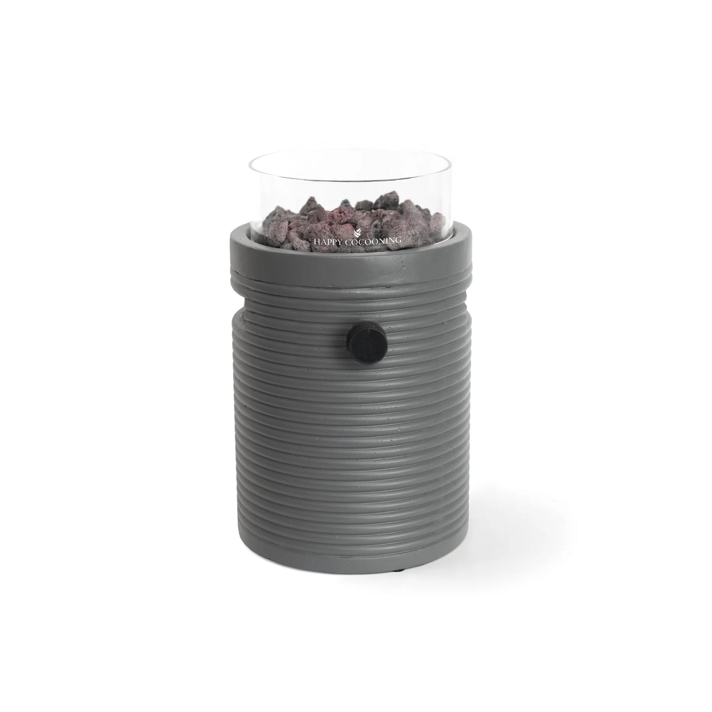 Gray ribbed ceramic oil burner with clear glass top holding dark stones for happy cocooning lumi groove tabletop gas fireplace use
