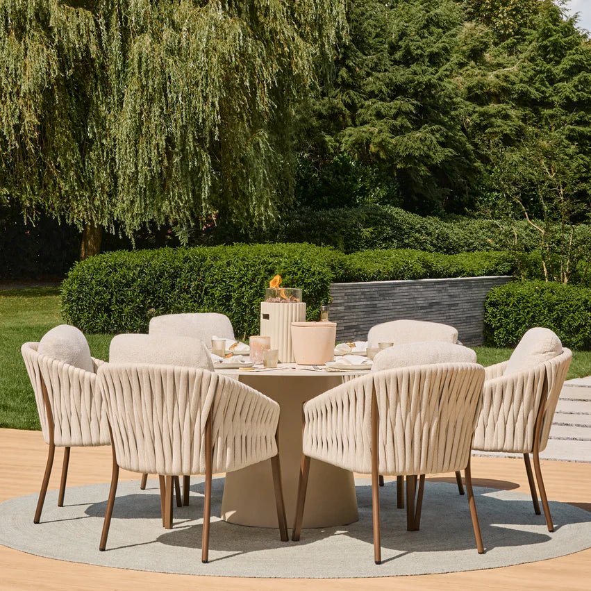 Beige woven outdoor dining set with wooden legs and matching round table paired with happy cocooning lumi rib tabletop gas fireplace