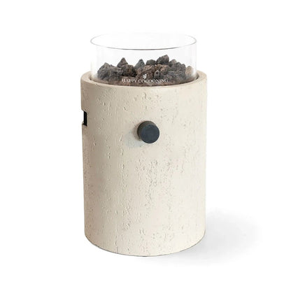 Cream-colored textured cylindrical outdoor fire pit with clear glass top, dark lava rocks, and black control knob by Happy Cocooning