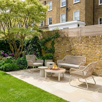 Beige woven wicker patio set with cream cushions and happy cocooning riviera 80 gas fire pit table in use