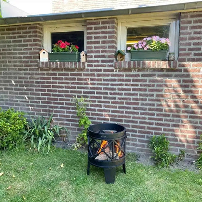 Black metal heat firecask fire basket with lattice design burning logs inside for outdoor fire pit use