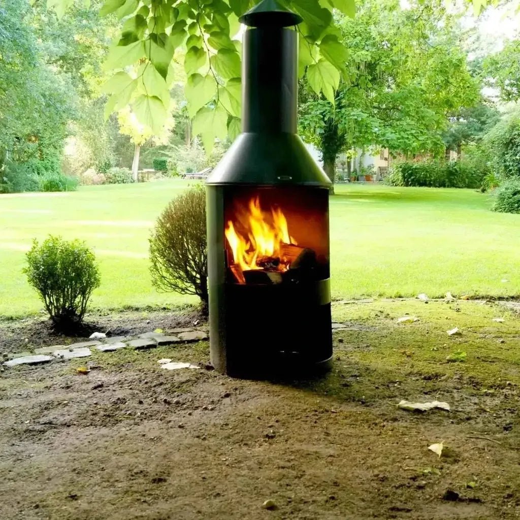 Black metal HEAT Larvik outdoor fireplace with a tall chimney and visible flames inside for outdoor heating