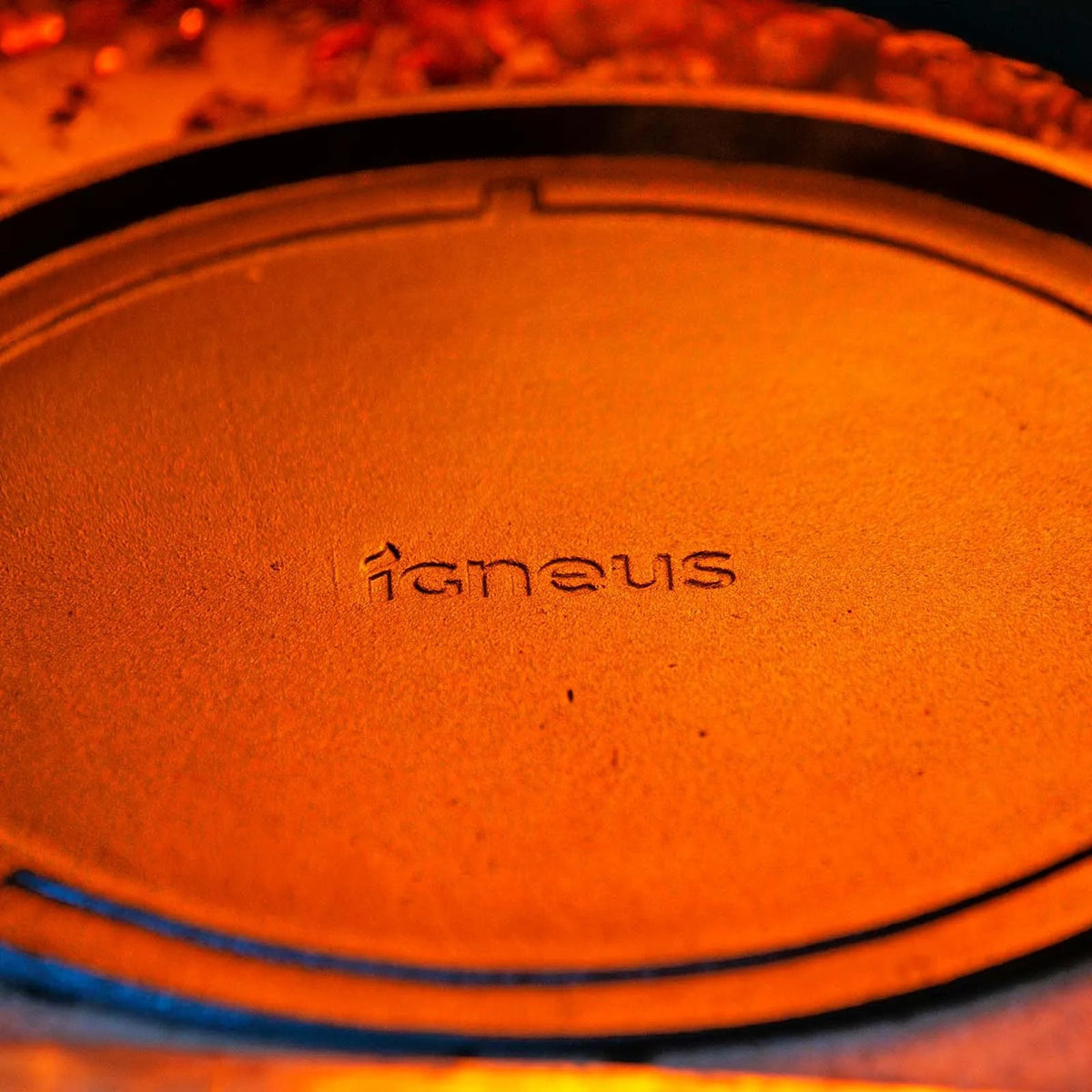 Orange textured circular lid with igneus embossed for igneus cast iron tuscan grill pizza oven cooking grate