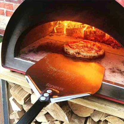 Bronze-colored heat-resistant pizza peel with black handle and silver rivets for igneus classico wood-fired pizza oven
