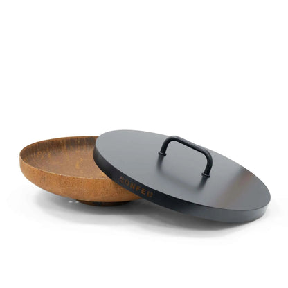 Black steel lid with handle resting on rusted steel fire pit bowl for BonFeu BonBowl and BonBowl Plus