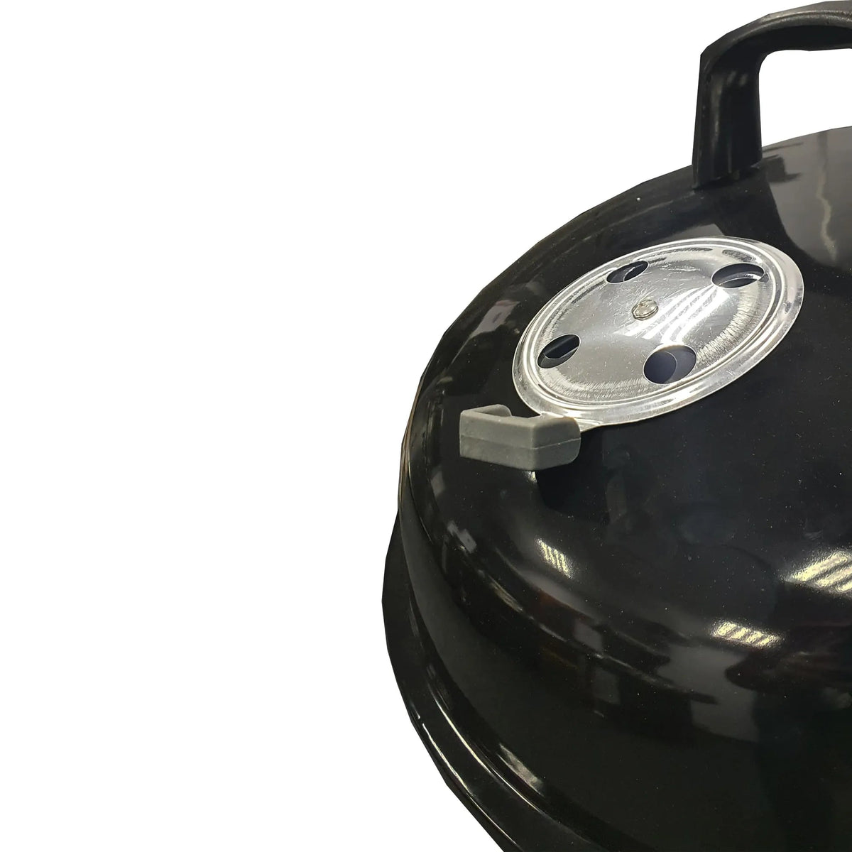 Lifestyle 22 inch kettle charcoal BBQ featuring a black glossy enamel-coated cast iron grill with silver vented lid and gray handle