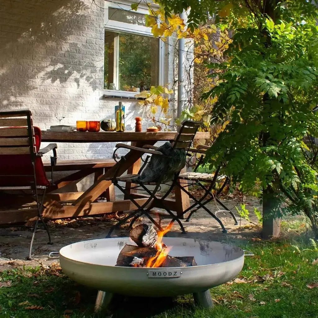 Silver metal fire pit with sleek modern design and moodz engraving from the moodz feet and handle fire bowls collection