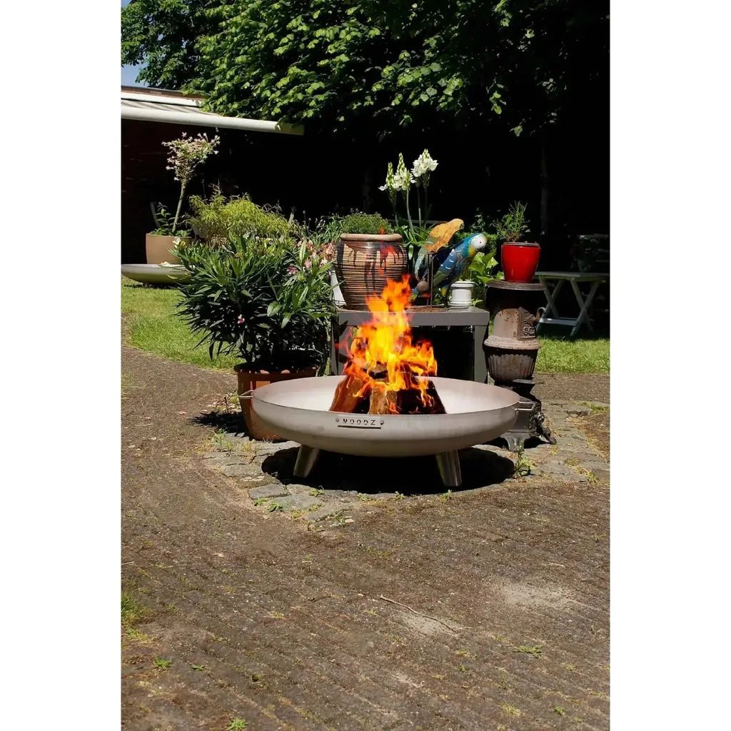 Moodz feet and handle fire bowl with matte gray finish and three sturdy legs made of corten and stainless steel