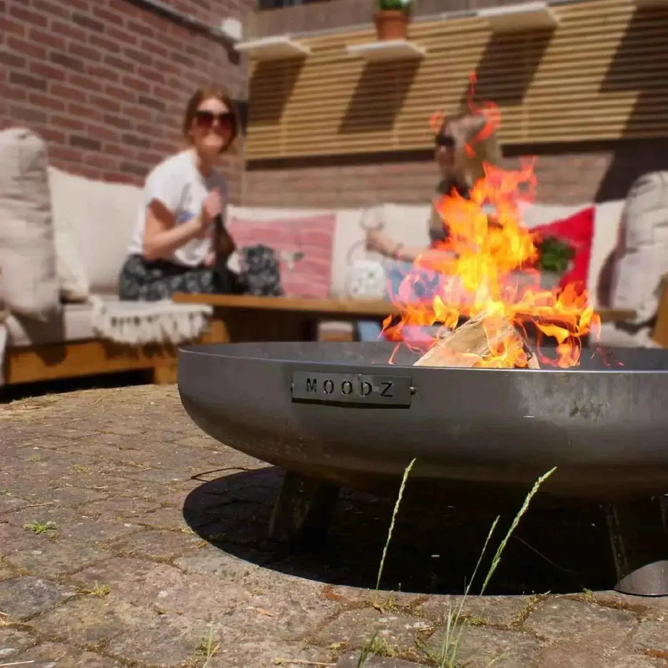 Black metal fire pit with moodz engraved on the side from moodz feet and handle fire bowls in corten and stainless steel