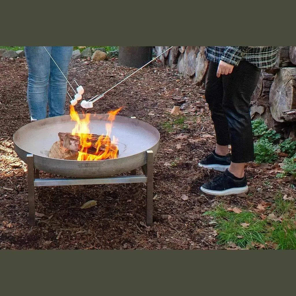 Round metal fire pit with sturdy stainless or carbon steel frame and visible flames designed for garden fire bowls