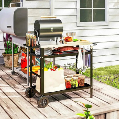 Black metal Outsunny BBQ trolley with stainless steel top shelf holding a grill and cooking items on wheels