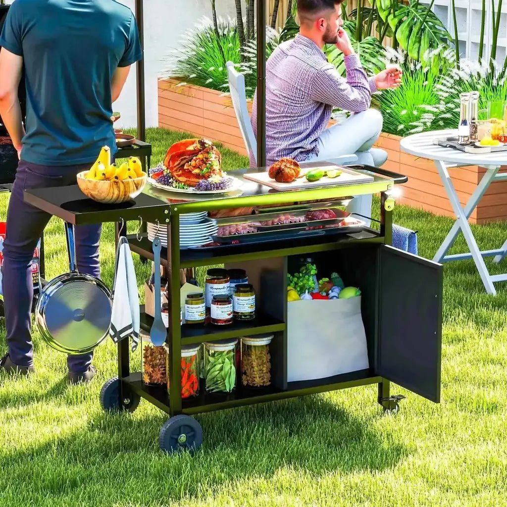 Outsunny outdoor bbq trolley in black metal with green accents stainless steel top and open shelving stocked with spices and produce