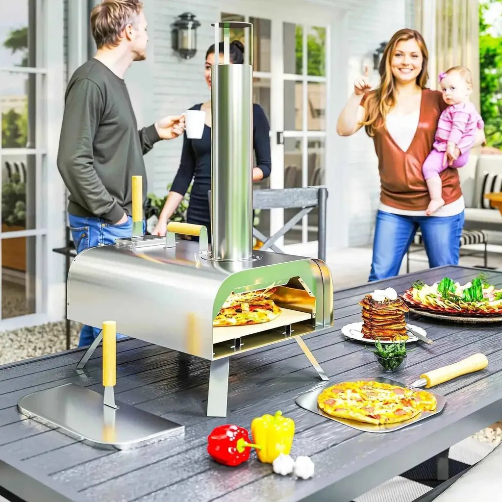 Outsunny outdoor stainless steel pizza oven with tall cylindrical chimney and yellow-handled tools nearby