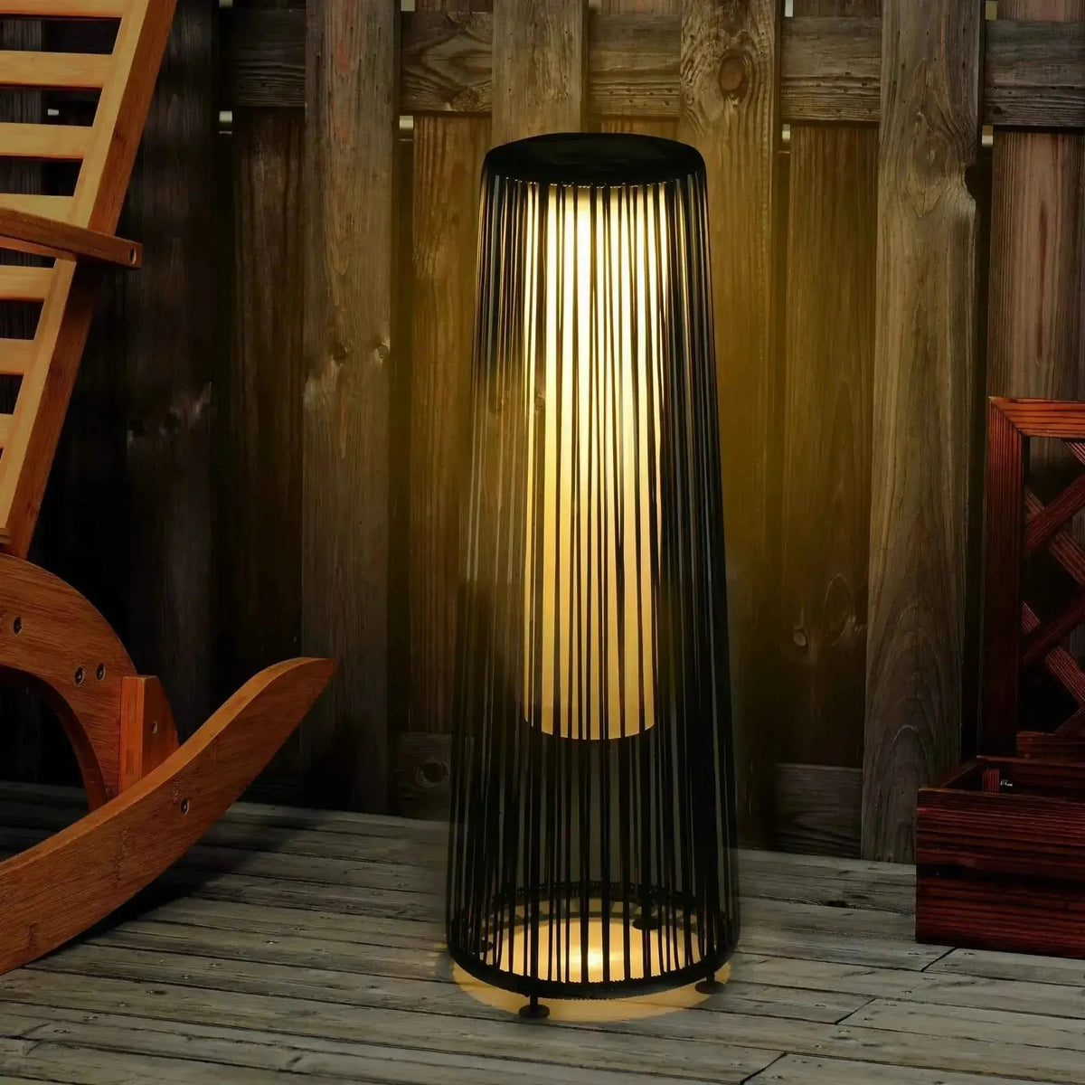 Outsunny solar powered black woven resin wicker lantern floor lamp with vertical slats and warm glowing light