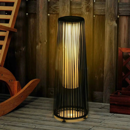 Outsunny solar powered black woven resin wicker lantern floor lamp with vertical slats and warm glowing light
