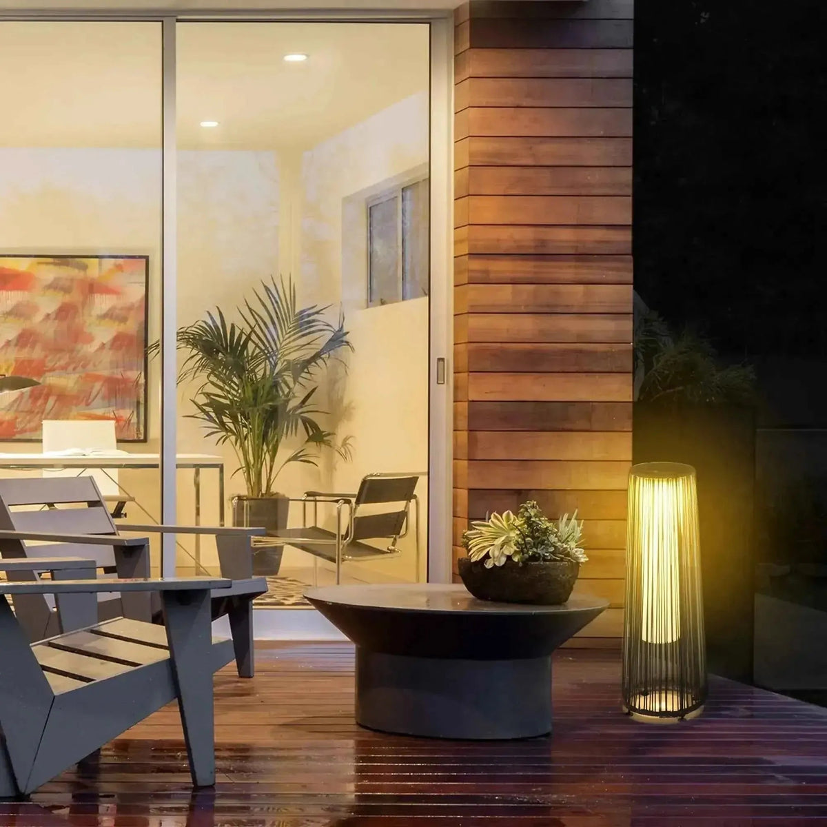 Outsunny solar powered woven resin wicker lantern in black with a modern cylindrical slatted design and warm light