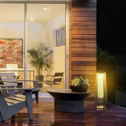 Outsunny solar powered woven resin wicker lantern in black with a modern cylindrical slatted design and warm light