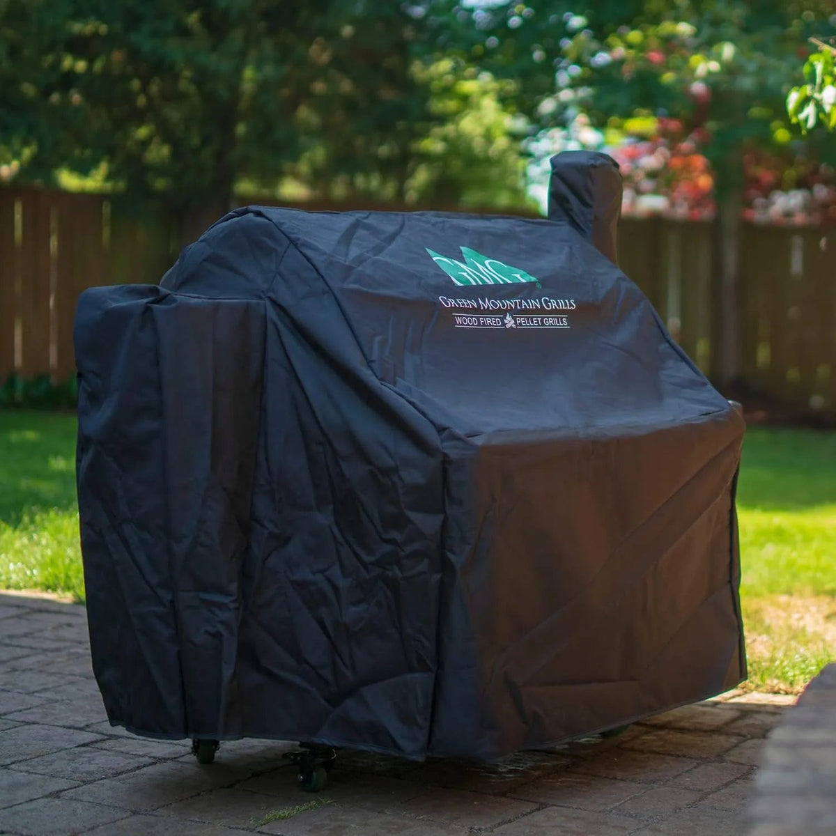 Black protective cover for green mountain grills wood-fired pellet grill designed for outdoor use