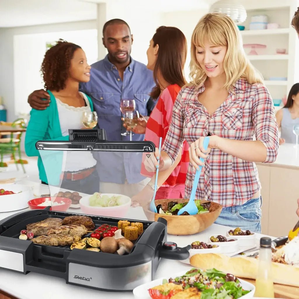 Steba 2200W tabletop bbq grill in black and silver with transparent lid for grilling meats vegetables and corn