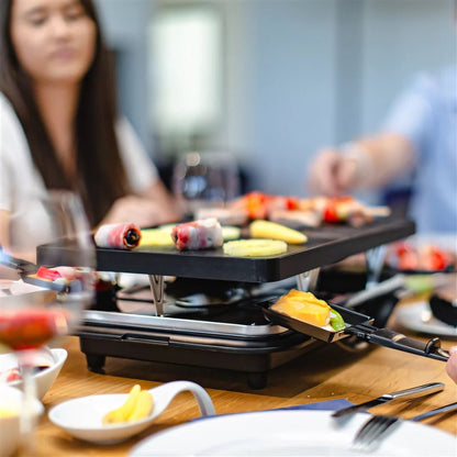 Black steba rc28 premium electric cast raclette grill with multiple cooking surfaces for sharing food