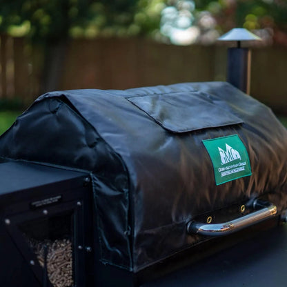 Black fabric thermal blanket grill cover with green mountain grills logo patch for GMG pellet grills