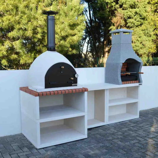 XclusiveDecor Napoli outdoor kitchen featuring a white wood fired pizza oven with black door and red brick countertop accents