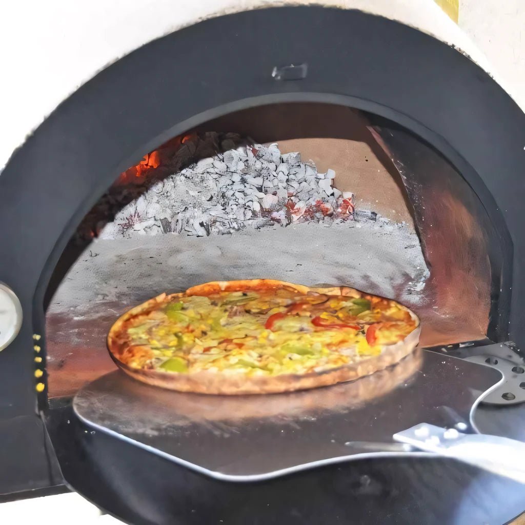 A freshly baked vegetable pizza with colorful peppers on a metal peel inside the XclusiveDecor Napoli outdoor kitchen oven