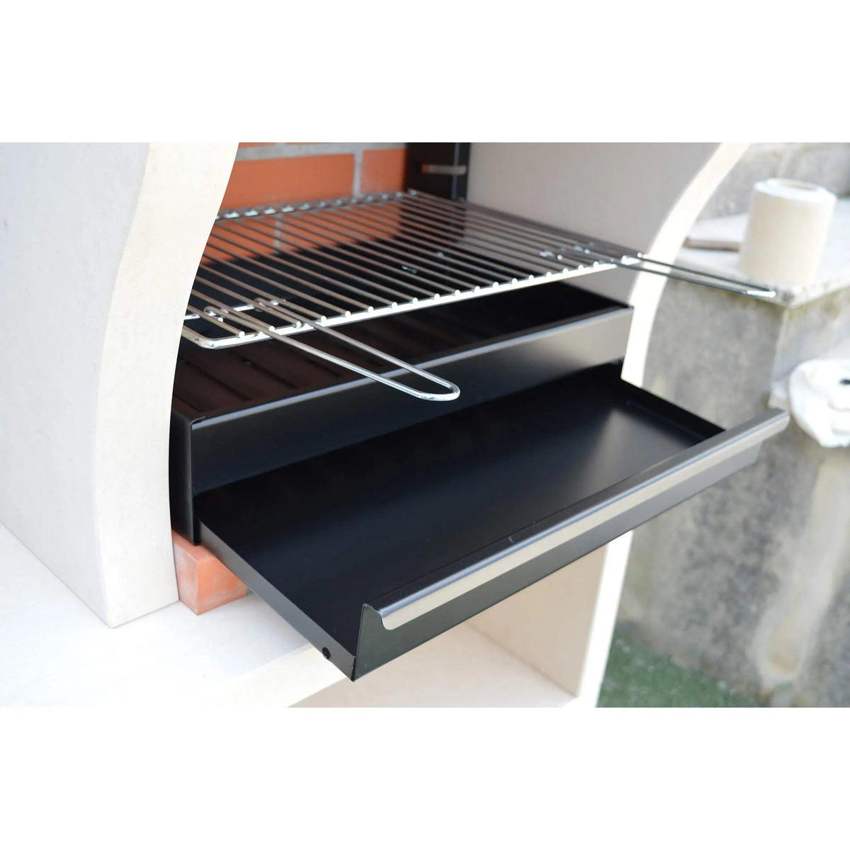 Black metal grill rack with matching tray and silver wire tool inside xclusivedecor napoli outdoor kitchen oven