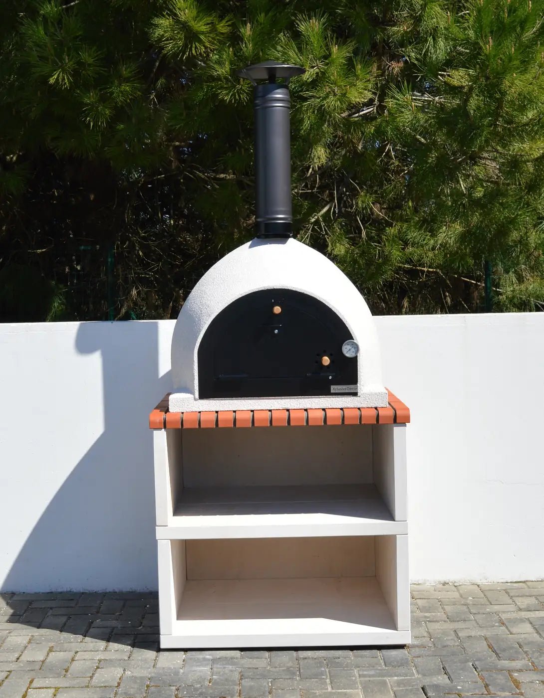 White ceramic xclusivedecor royal wood fired oven with black chimney and terracotta tile accents on stand complete set