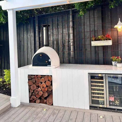 Cream-colored ceramic outdoor wood fired pizza oven with black chimney and arched door by XclusiveDecor Royal PO2580